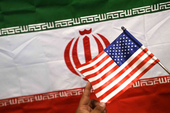 US, Iran and Pakistan flags on display at a shop in Karachi