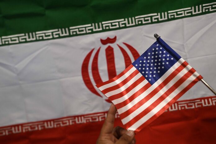 US, Iran and Pakistan flags on display at a shop in Karachi
