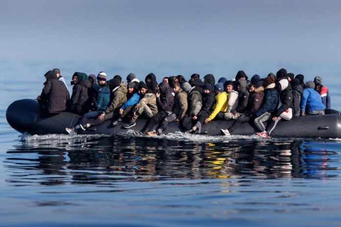 Migrants cross the English Channel on a small boat